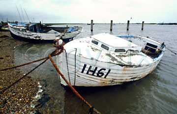Comp image : boat0106 : Old white clinker-built fishing boat moored by the Suffolk shore under a leaden sky