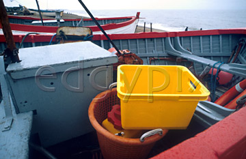 Comp image : boat0111 : Ropes and tackle in a red and pale blue fishing boat on the shore at Aldeburgh, Suffolk, England, with a bright yellow box