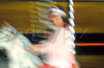 Comp image : impr0119 : Blurred image of a girl on a horse on a fairground carousel