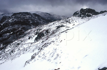 Comp image : ld02006 : The High Stile ridge from Fleetwith Pike, in the English Lake District. Snow underfoot and a heavy sky above.