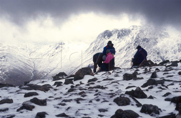 Comp image : ld02010 : Walkers resting under a heavy sky on snow-covered High Stile in the English Lake District