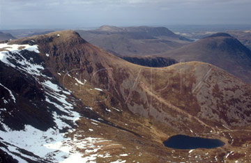 Comp image : ld02509 : Red Pike and Bleaberry Tarn seen from High Stile in the English Lake District. Snow still lies on north facing slopes.
