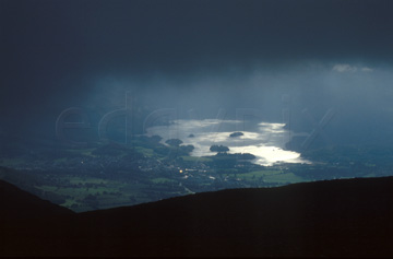 Comp image : ld03020 : Misty sun on Derwentwater and Keswick, under very heavy cloud, seen from Skiddaw in the Lake District