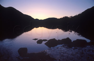 Comp image : ld03418 : Reflected silhouette of the fells at sunset in the still waters of Buttermere, in the English Lake District