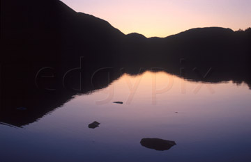 Comp image : ld03420 : Reflected silhouette of the fells at sunset in the still waters of Buttermere, in the English Lake District