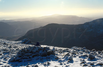 Comp image : ld04116 : Looking south-west into the winter sun from snow-covered Scafell Pike in the English Lake District