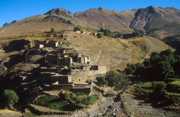 Comp image : mgun0819 : A Berber village of mud-brick houses nestling in the hillside across a valley in the High Atlas mountains of Morocco