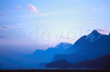 Comp image : sils0305 : Wispy clouds in an evening sky over receding misty blue mountains in Switzerland