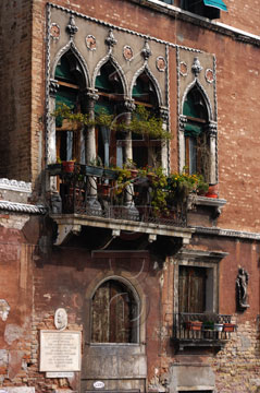 Comp image : ven021500 : Part of an old red brick building with stone Moorish style windows and a balcony in Venice, Italy