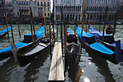 Gondolas moored in strong sunshine on the Grand Canal in Venice, Italy