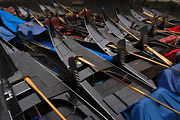 Strong pattern composition of closely packed black gondolas moored on a canal in Venice, Italy