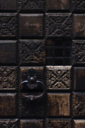Close-up of part of an old carved wooden door with a cast iron handle in Venice, Italy