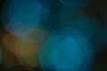 Subdued abstract photo with overlapping greeny-blue and orange translucent circles