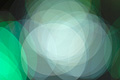 Bright abstract photo with overlapping white and green translucent circles
