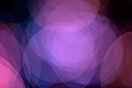 Abstract photo with overlapping purple and blue translucent circles on a dark background