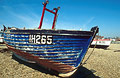 Fishing boat with worn paint on the shingle at Aldeburgh, Suffolk, England