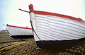 White fishing boats against a plain sky on the shingle at Aldeburgh, Suffolk, England