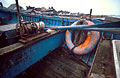 Lifebelt and oars in a blue painted fishing boat on the shore at Aldeburgh, Suffolk, England