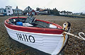White and red fishing boat on the shingle at Aldeburgh, Suffolk, England