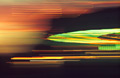 Strongly blurred lights of a fairground ride at night