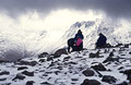 Walkers resting under a heavy sky on snow-covered High Stile in the English Lake District