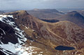 Red Pike and Bleaberry Tarn seen from High Stile in the English Lake District. Snow still lies on north facing slopes.
