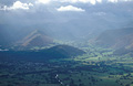 A view south along the Newlands valley from Skiddaw, near Keswick in the English Lake District, under a darkening sky, showing the Cat Bells ridge and Swinside