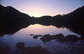 Reflected silhouette of the fells at sunset in the still waters of Buttermere, in the English Lake District