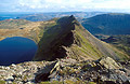 The sharp ridge of Striding Edge seen from Hellvellyn, in the English Lake District, in autumn sunshine, with Red Tarn below