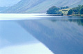 Delicate autumn reflection of the English Lake District fells in the still surface of Crummock Water, near Buttermere