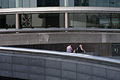Dramatic shapes of buildings in the 'More London' development on the south bank of the River Thames in London, England. Two people have a picnic.