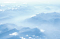 Misty light blue aerial view of the Swiss Alps