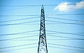 Electricity pylon and cables against a light blue sky
