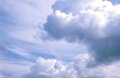 Big white cumulus and stratocumulus clouds in a sunny blue sky