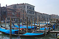 Looking across the Grand Canal [Canal Grande] to the Palazzo Farsetti in Venice, Italy, with gondolas moored in the foreground