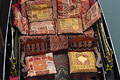 Looking down on highly decorated cushions in a gondola on a canal in Venice, Italy