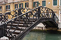 Old cast iron bridge over a canal in Venice, Italy